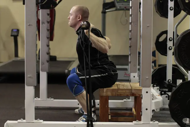 Box Squat with Bands, finishing position