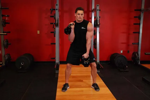 Double Kettlebell Alternating Hang Clean, finishing position
