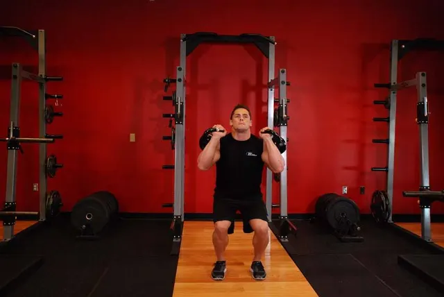 Double Kettlebell Push Press, finishing position