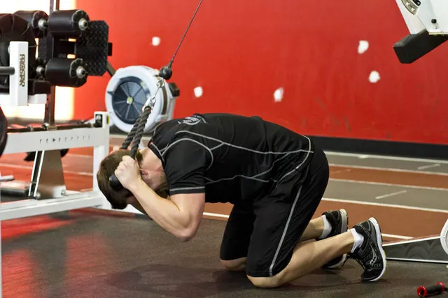 Kneeling Cable Crunch With Alternating Oblique Twists, finishing position