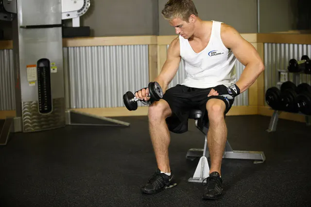 Seated One-Arm Dumbbell Palms-Down Wrist Curl, finishing position