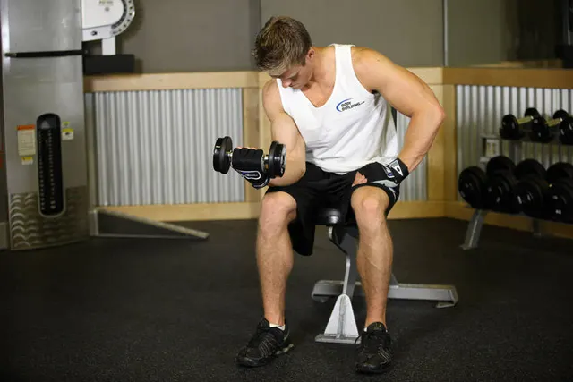 Seated One-Arm Dumbbell Palms-Up Wrist Curl, finishing position