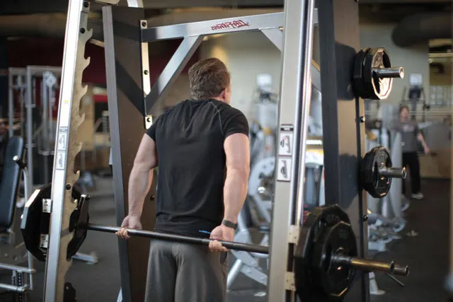 Smith Machine Behind the Back Shrug, finishing position