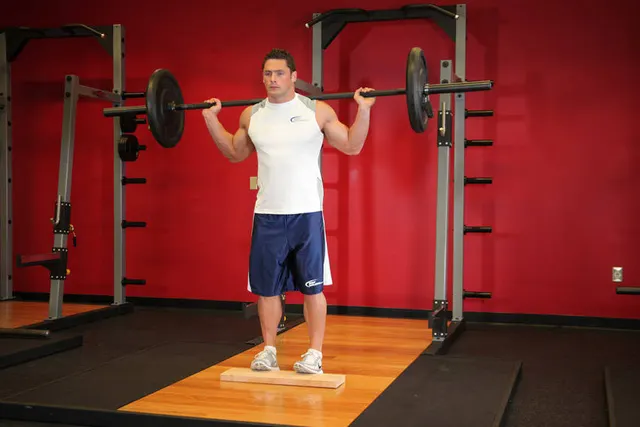 Standing Barbell Calf Raise, finishing position