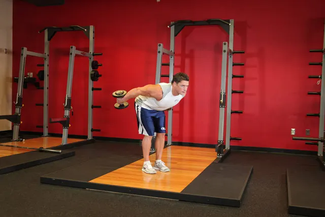 Standing Bent-Over Two-Arm Dumbbell Triceps Extension, finishing position