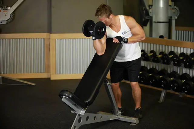 Standing One-Arm Dumbbell Curl Over Incline Bench, finishing position