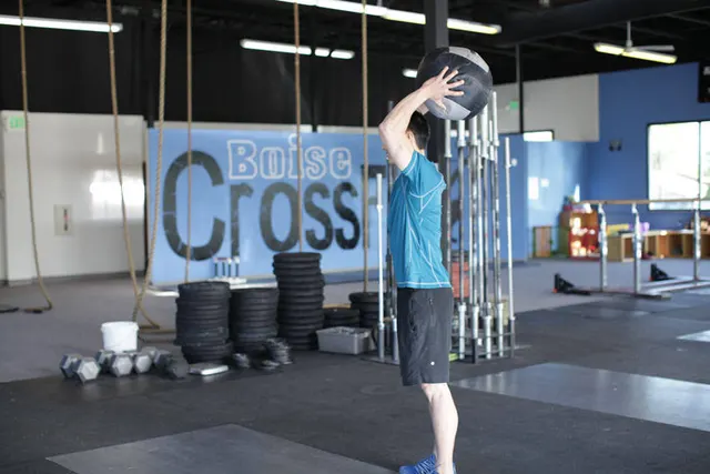 Standing Two-Arm Overhead Throw, finishing position